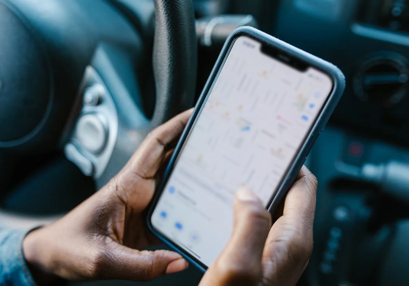 A driver checking the delivery route on a smartphone map